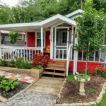 Exterior view of the Crimson Poppy tiny home with landscaped garden and covered porch in Flat Rock, North Carolina.