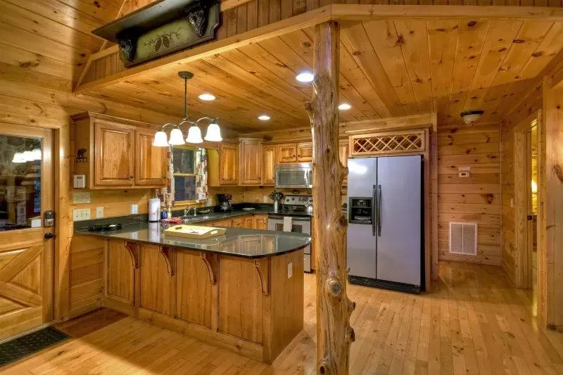 Fully equipped wooden kitchen with breakfast bar at Mountain High Lodge