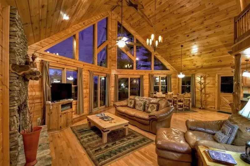 Cozy great room with leather seating, vaulted ceiling, and large windows