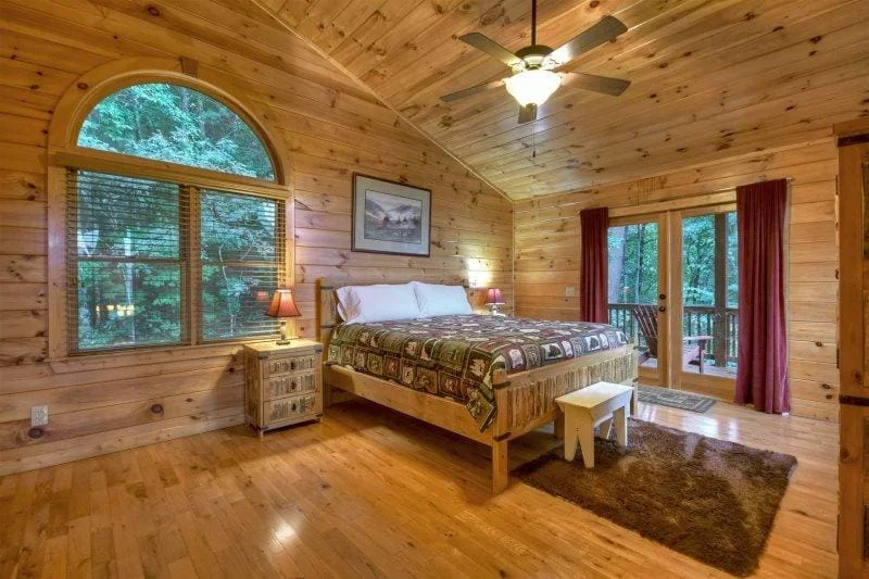 Spacious king bedroom with deck access at Mountain High Lodge