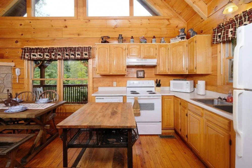 Open-plan kitchen and dining area inside Scooter Bears Den cabin