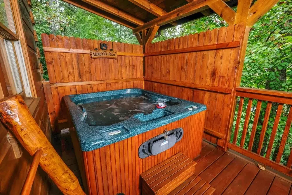 Private hot tub on the covered deck at Scooter Bears Den cabin